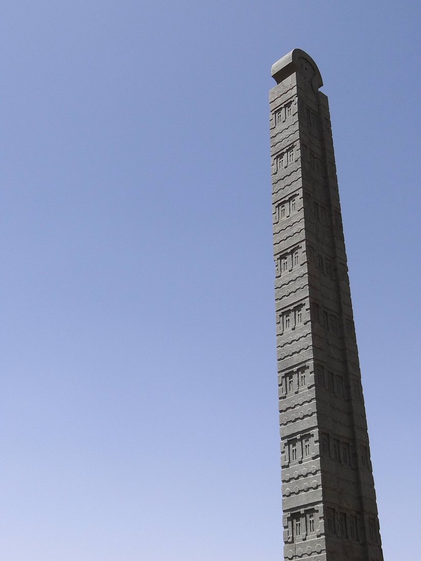 The upper part of one of the stelae in the main stelae field at Aksum: stone “storeys” with false windows and rows of projecting beam ends, known in Aksumite architecture as monkey heads.