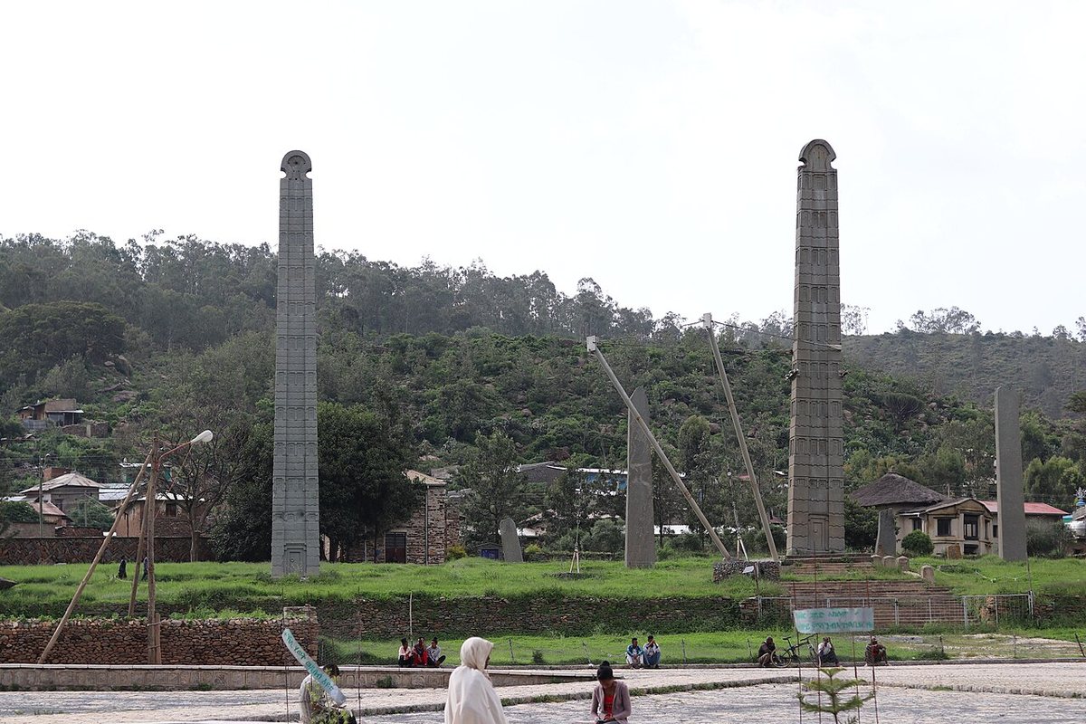 The main stelae field at Aksum. The tall stone stelae, carved with false windows and doors, imitate multi-storey buildings and marked graves; the two tallest standing are the so-called Stela of King Ezana and the obelisk that stood in Rome from 1937 to 2005. Props and cables secure one of them.