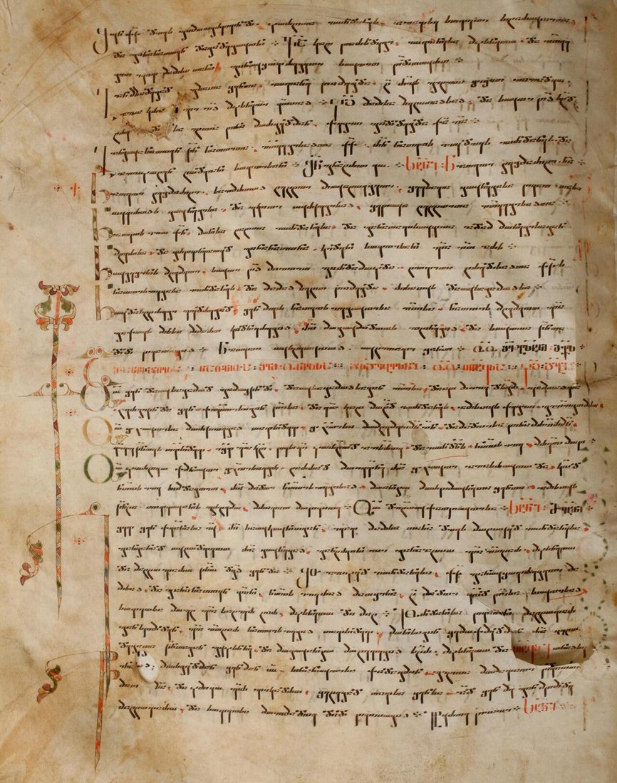 A page from the Iadgari, a collection of liturgical hymns compiled by Mikael Modrekili in the 10th century. The text is in Nuskhuri with red Asomtavruli initials, the combination known as Khutsuri.