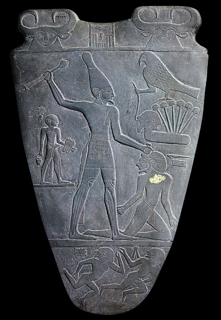 The Narmer Palette (c. 3100 BCE), one of the earliest records of Egyptian writing: the king's name at the top is written with the signs of a catfish and a chisel.