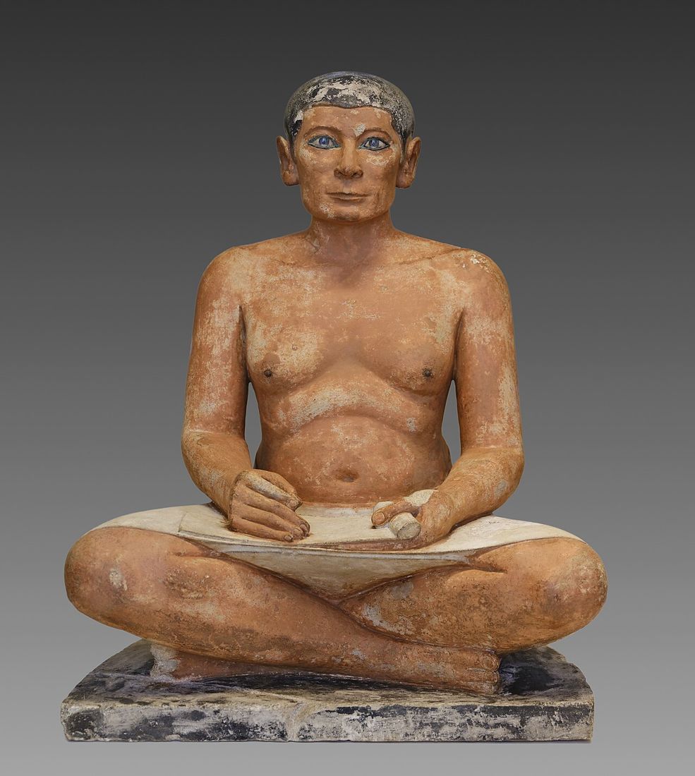 The Seated Scribe with an unrolled papyrus on his lap, painted limestone from Saqqara, Old Kingdom. Louvre, Paris.