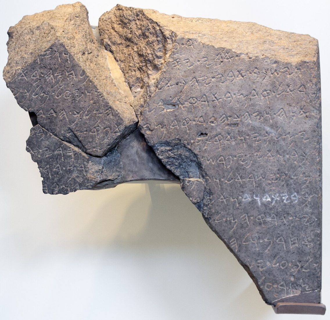 The Tel Dan stele (9th century BCE) in the Israel Museum, Jerusalem. The letters highlighted in white spell bytdwd, by the prevailing reading “House of David”.