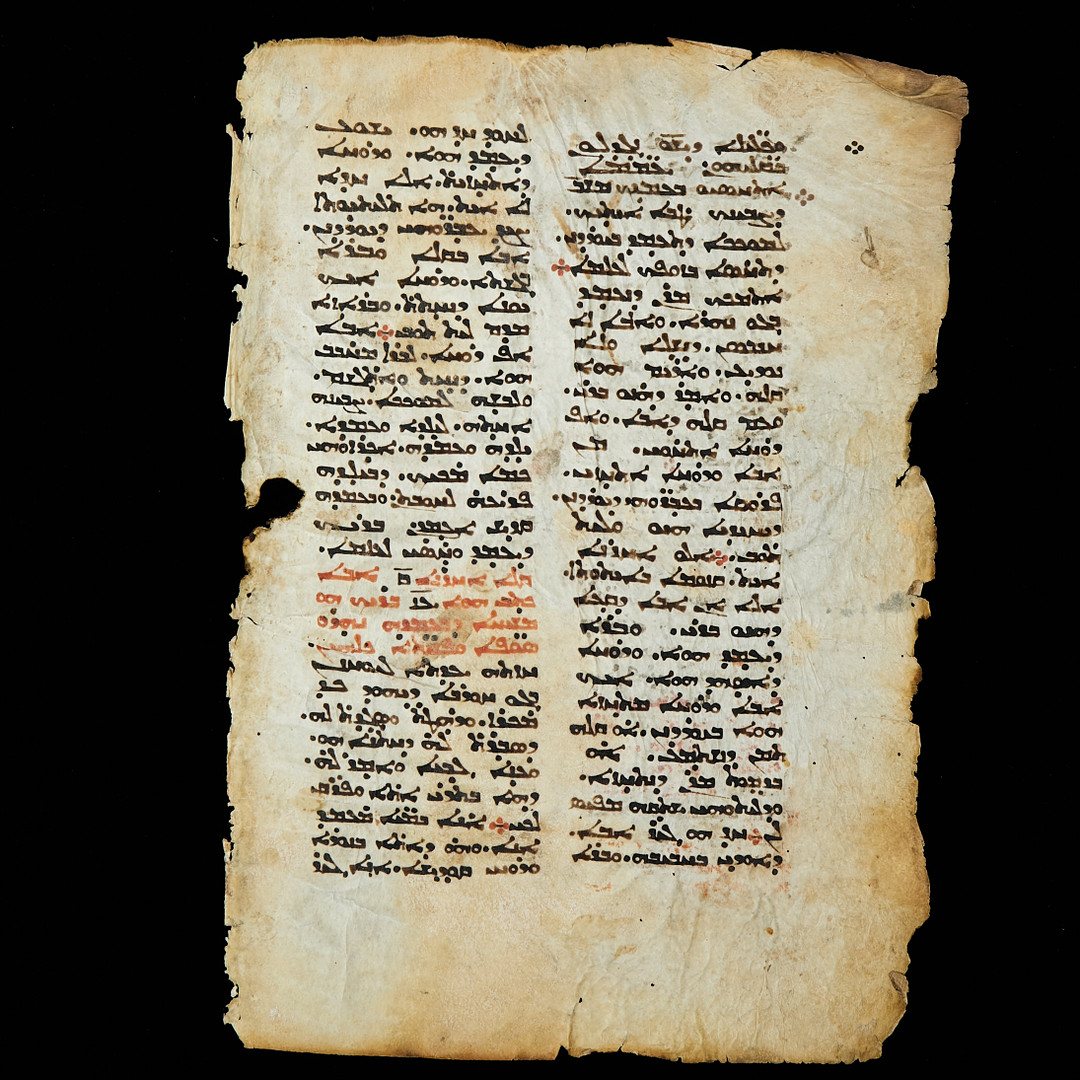 A leaf of an 11th-century Syriac liturgical manuscript in two columns, with headings in red.