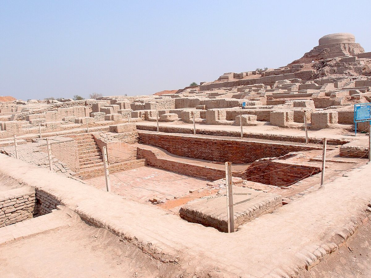 Excavations at Mohenjo-daro (Sindh, Pakistan): the Great Bath of baked brick in the foreground, the mound with a later Buddhist stupa behind.