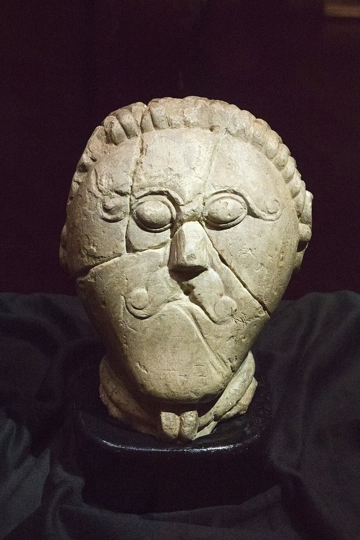 The stone head from Mšecké Žehrovice (Rakovník district), found in 1943: a man with a torc, a curled moustache and curled eyebrows. La Tène period; it was deposited in a pit around 100 BCE. National Museum, Prague.