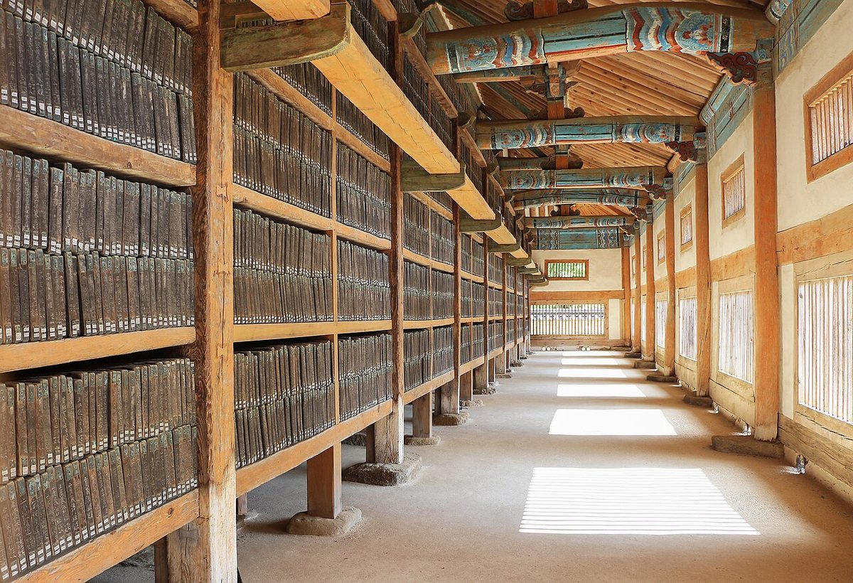Woodblocks of the Tripitaka Koreana in the depositories of Haeinsa Temple. The blocks stand upright on the shelves, and wooden slats in the windows keep the air circulating.
