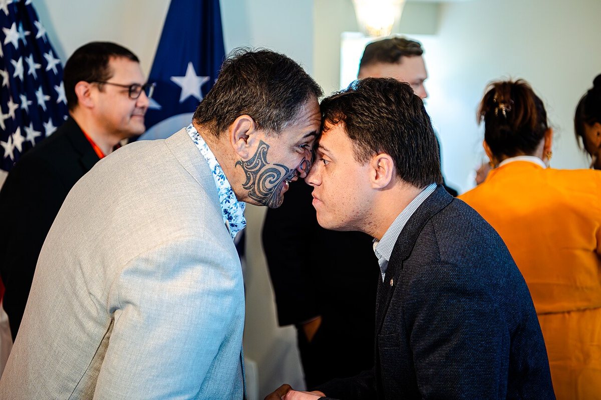 A hongi, the greeting in which two people press noses and foreheads, at a reception for Māori Language Week (Te Wiki o te Reo Māori) in Wellington on 19 September 2024. The man on the left has a Māori-style facial tattoo (moko).